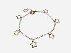 SPARQ delicate gold-tone stainless steel bracelet with multiple open star charms and a fine link chain.