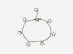 SPARQ delicate gold-tone stainless steel bracelet with multiple open star charms and an adjustable clasp.