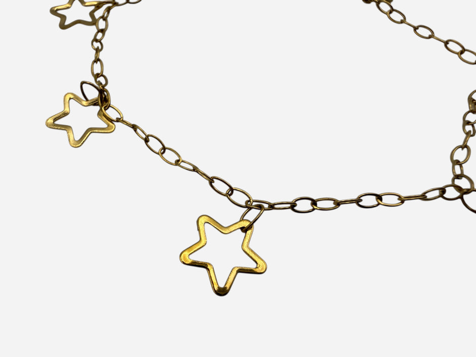 SPARQ delicate gold-tone stainless steel bracelet with multiple open star charms on a fine link chain. Adjustable clasp.