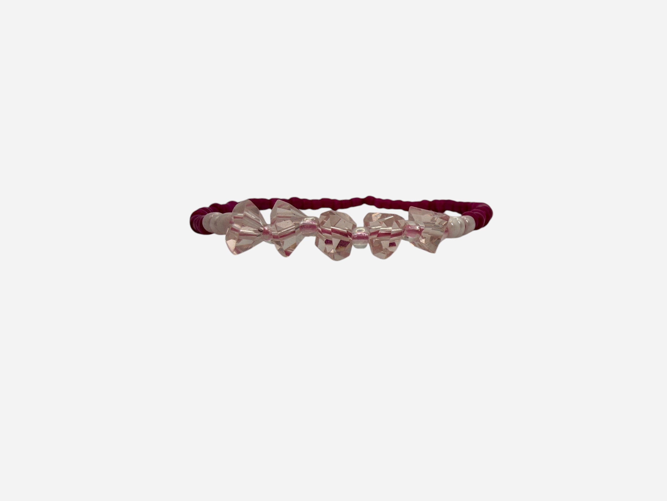 SPARQ pink seed bead stretch bracelet with clear crystal bow charms. Elastic design for comfortable wear.