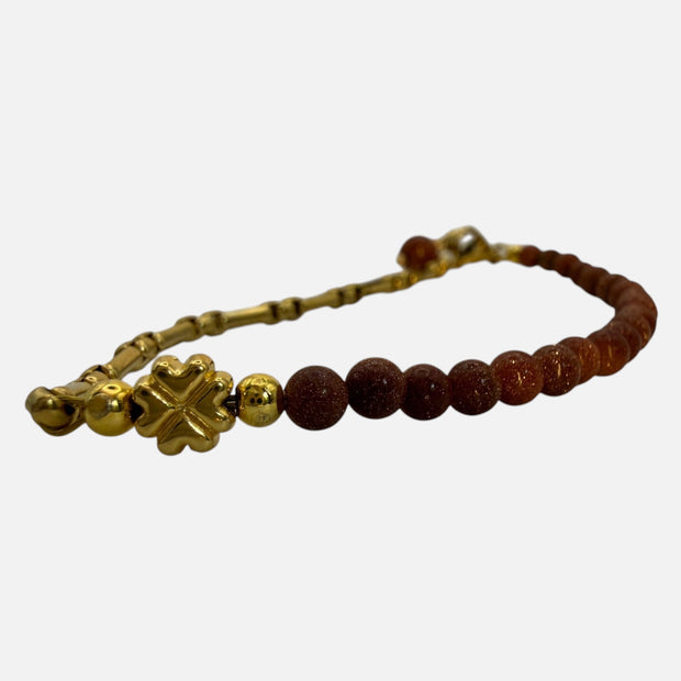 SPARQ armband met bruine zandsteen kralen, goudkleurige schakelketting en een klavertjevier bedel.