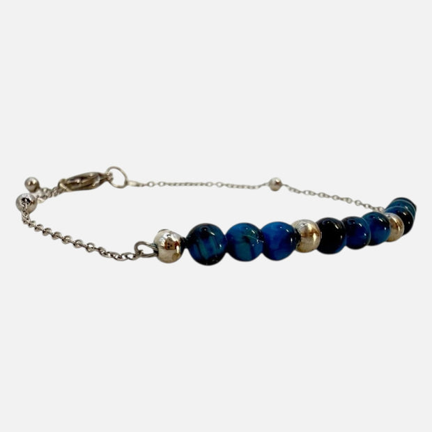 SPARQ Blue Tide armband met blauwe kralen en een verfijnde zilverkleurige ketting, verstelbaar en waterbestendig.