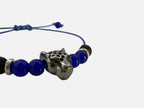 SPARQ blauwe kralenarmband voor dames met een zilverkleurige luipaardbedel en verstelbaar blauw koord.