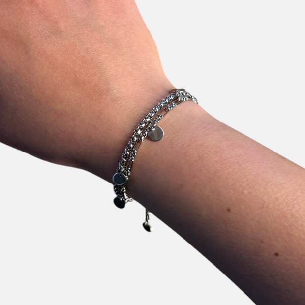 SPARQ dubbele zilverkleurige schakelarmband met ronde bedels om een pols voor een elegante en moderne uitstraling.