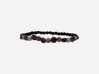 SPARQ beaded stretch bracelet with matte black lava beads, pink quartz, red jasper, and blue-grey stones. Elastic design for comfortable fit.