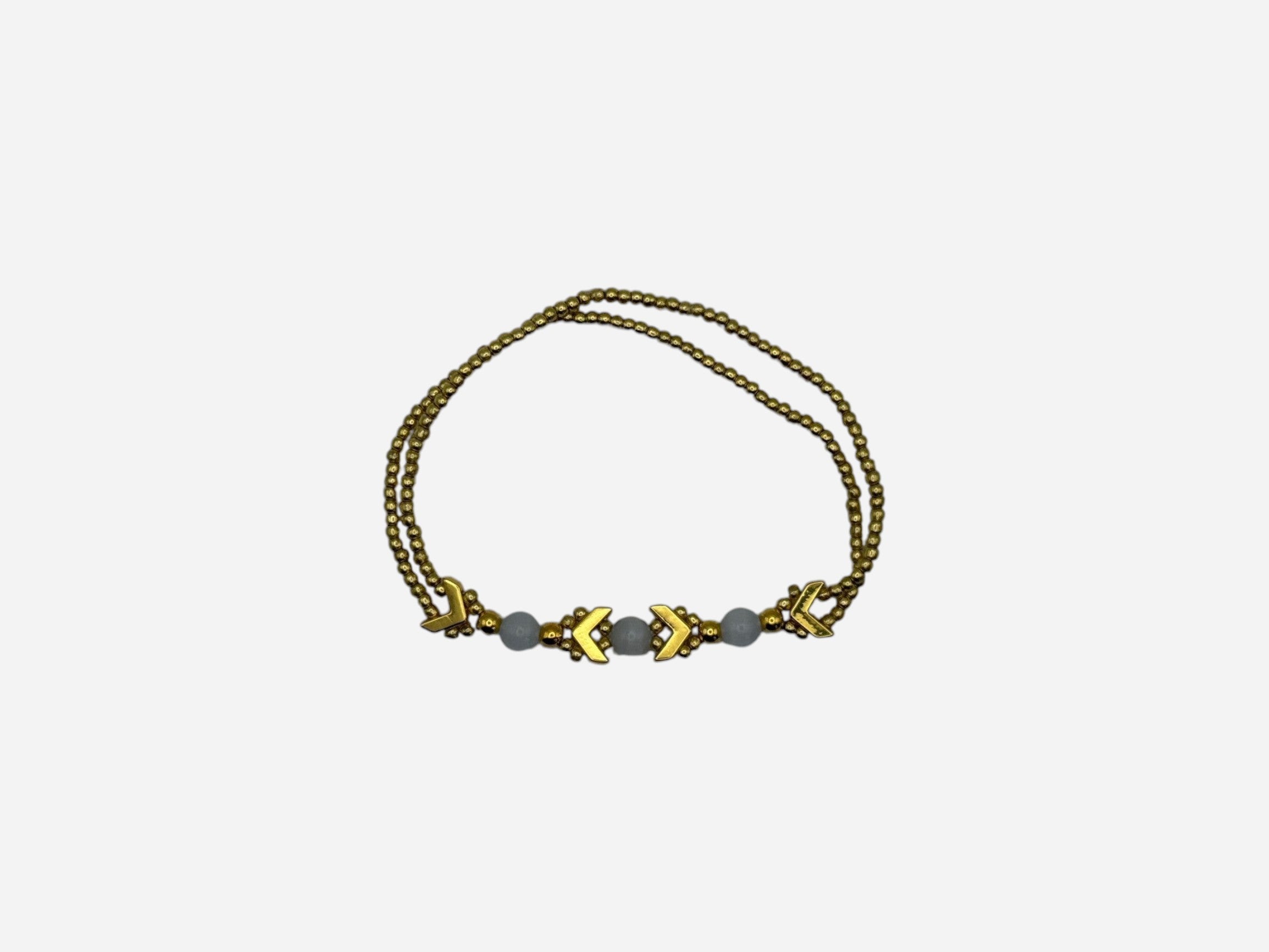 SPARQ gold-tone double strand bracelet with white beads and chevron accents.