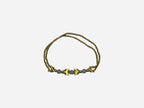 SPARQ gold-tone double strand bracelet with white beads and chevron accents.