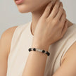 SPARQ black lava stone bracelet with clear crystal accents on a woman's wrist.