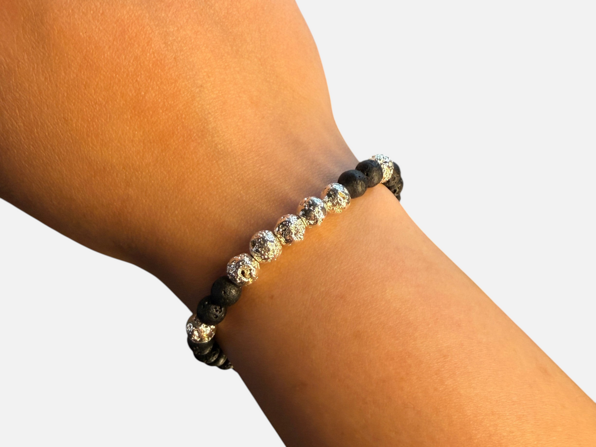 SPARQ kralenarmband met zwarte lavastenen en glanzende zilverkleurige accenten om de pols